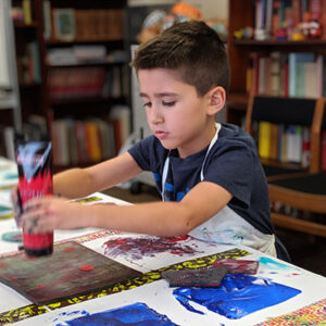 A young boy paints at The Write Place.